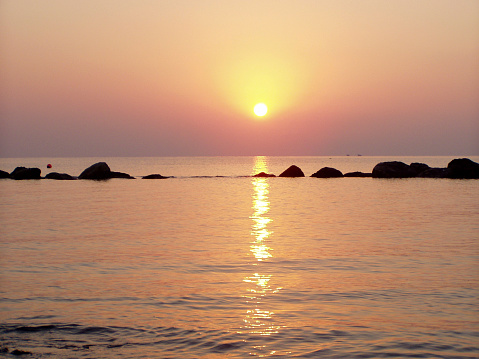 Orange sunset marine horizon landscape drone view. Sundown reflecting calm water
