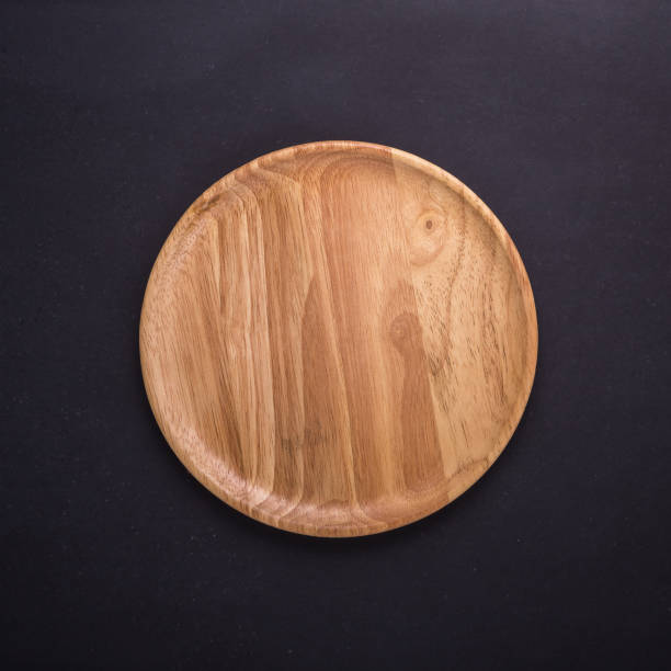 istock Bright empty wooden dish/bowl on black stone board background 915323954