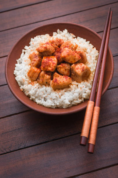 istock Rice with curry chicken in a bowl on wooden table 915324306