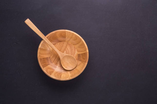 istock Bright empty wooden dish/bowl on black stone board background 915324778
