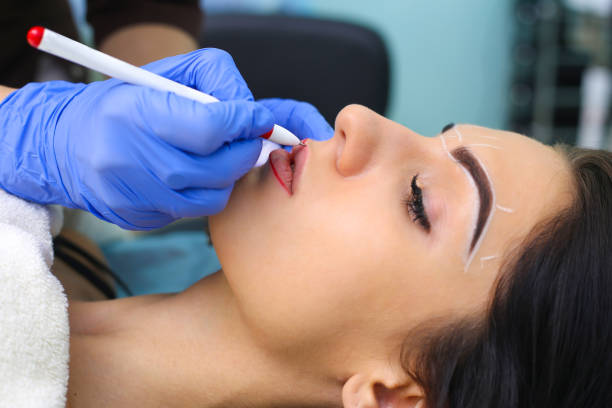 istock Cosmetologist making permanent makeup on woman's face 915325648