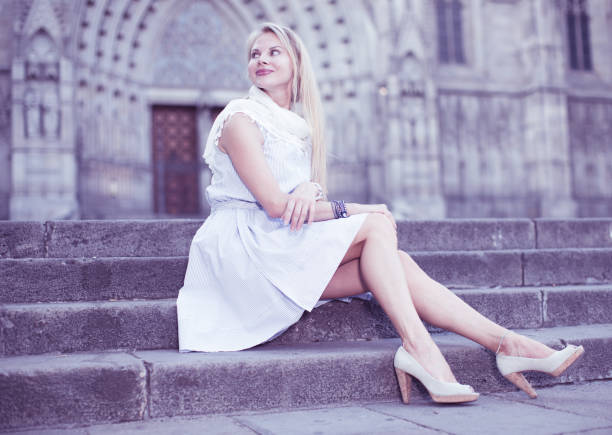 istock woman in shawl sitting on stone steps 915327688