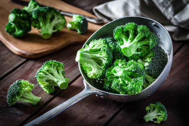 Broccoli in an old metal colander stock photo