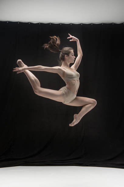 istock Young teen dancer on white floor background 915332482