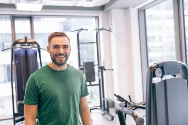 istock Smiling man surrounded by gym equipment. 915335226