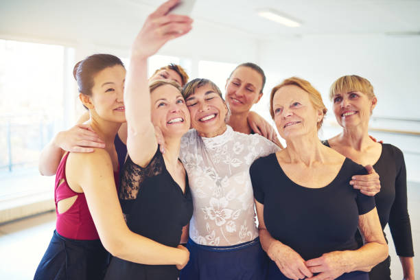 istock Smiling group of friends taking selfies in a dance studio 915336240