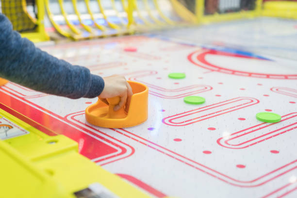 istock Happy boy playing air hockey 915344414