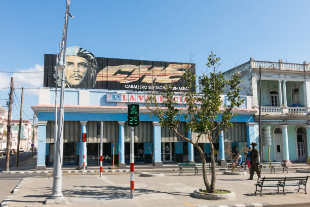 Cienfuegos, Cuba - January 3, 2017: Urban scene in Cienfuegos, Cuba. n the image, poster with Che Guevara, and statue of Benny More, the most famous Cuban bolero singer