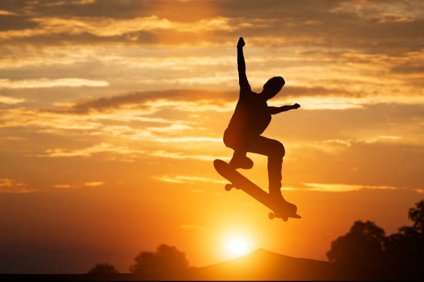 istock Skateboarder jumping at sunset. 915348268