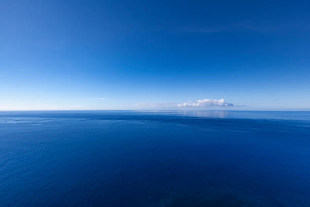 into the blue, ocean seascape with lonely cloud beautiful ocean seascape at the atlantic ocean, seen from madeira island in portugal. atlantic ocean stock pictures, royalty-free photos & images