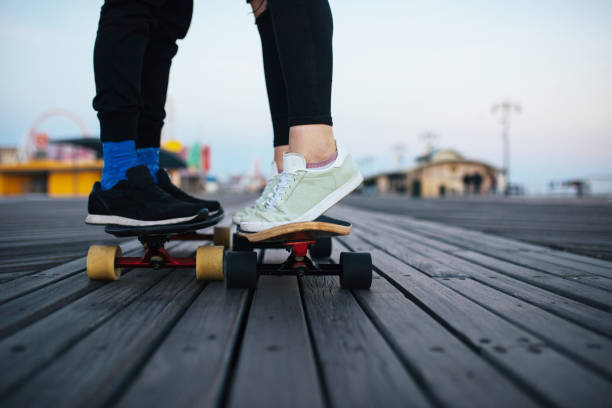 istock Longboarding couple together, romantic, feet only 915352430