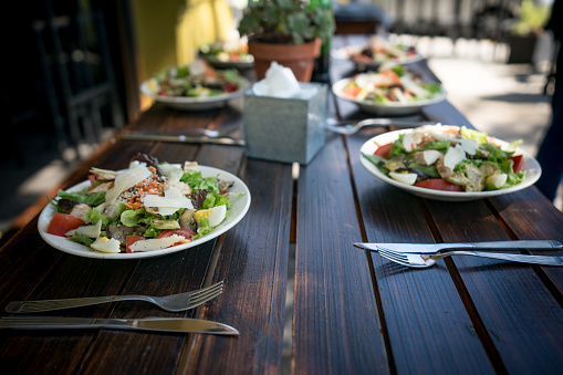 Delicious salads with egg, cheese and vegetables on a table ready to be eaten at a restaurant