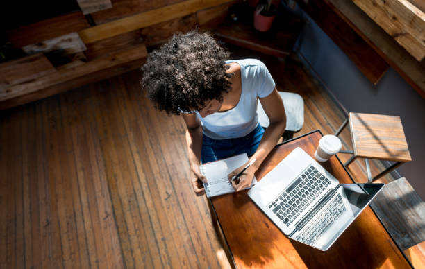 istock African american woman studying online and taking notes on a notepad 915352810