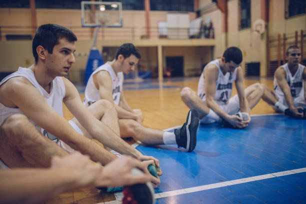 istock Basketball players stretching 915355590