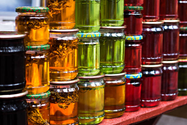 istock Multicolored honey in a jar on the counter. 915356492