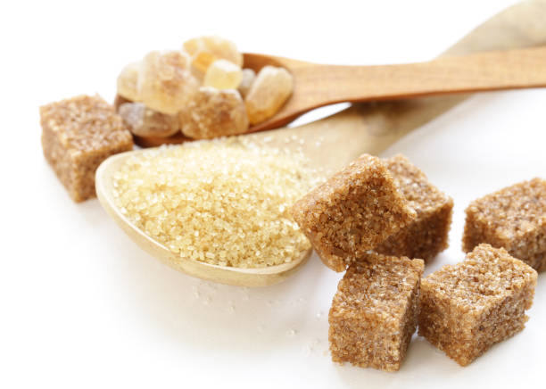 istock brown sugar sand and refined sugar on white background 915357444