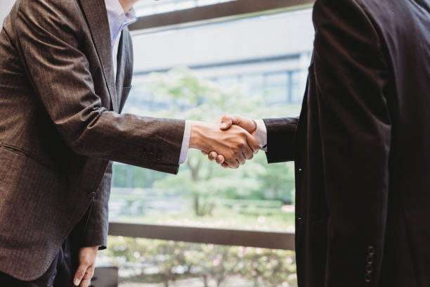 istock Japanese businessmen shaking hands 915358010