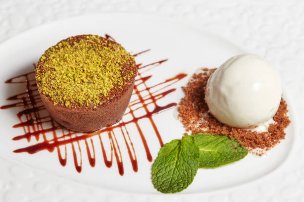 istock Chocolate brownie cake with vanilla ice cream on white plate 915361494