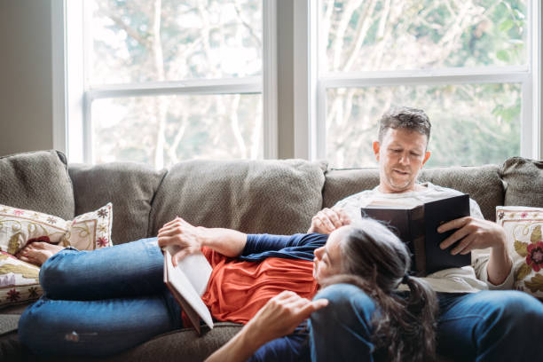 Mature Couple Relaxing with Books on Sofa