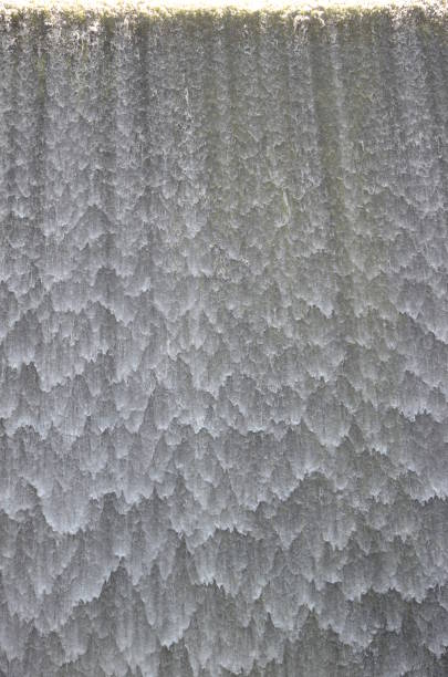 istock Yellow light on top of white falling water curtain 915361958