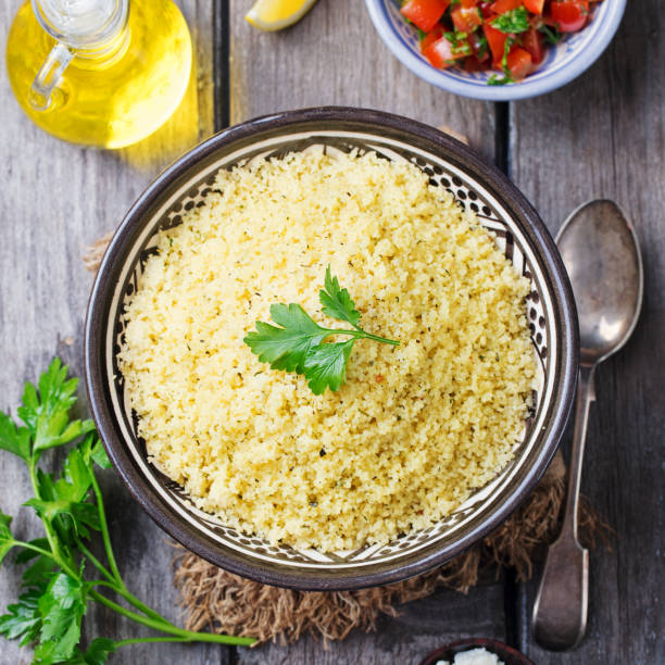 Couscous in bowl. Wooden background. Top view. Couscous in bowl. Wooden background. Top view. Copy space. couscous stock pictures, royalty-free photos & images