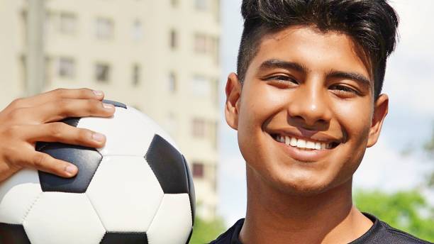 istock Smiling Young Hispanic Male Soccer Player 915371400