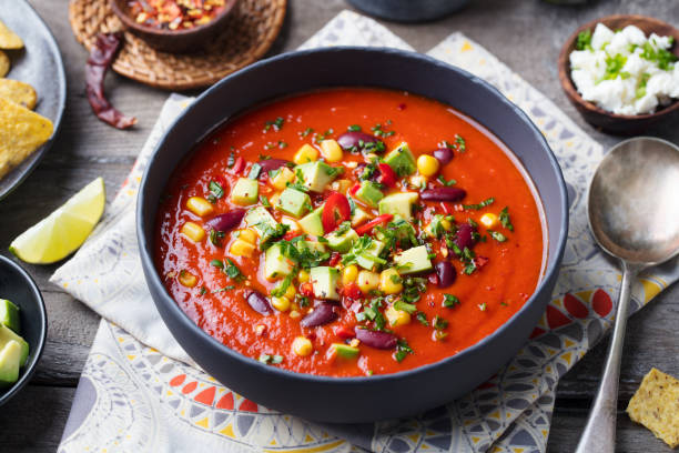 istock Mexican tomato, bean, bell pepper soup in black bowl. 915372690