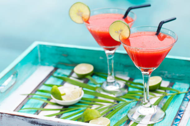 Strawberry margarita cocktail on colorful wooden background with palm leaf. Copy space Strawberry margarita cocktail on colorful wooden background with palm leaf. Copy space. daiquiri stock pictures, royalty-free photos & images