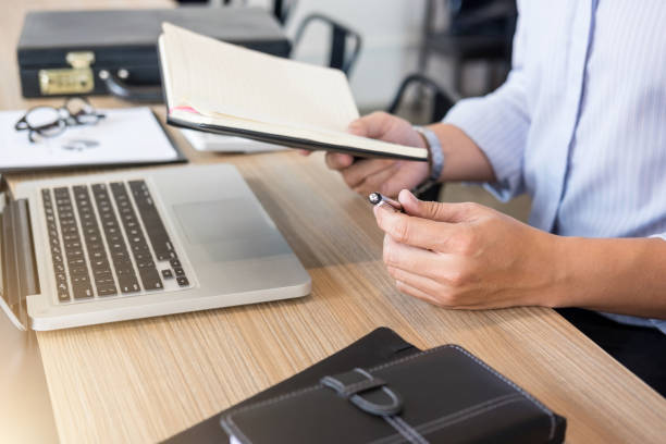 istock Professional businessman working at workplace with report, Doing finance on laptop, document graph and analysis business strategy to development profit 915383824