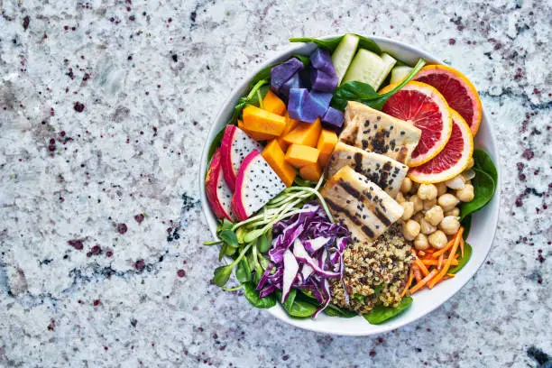 colorful buddha bowl with grilled tofu and dragon fruit with extra copyspace