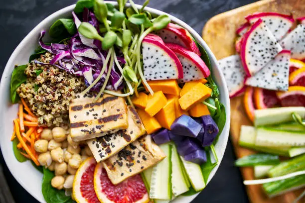 colorful buddha bowl with grilled tofu and dragon fruit close up shot from birds eye view