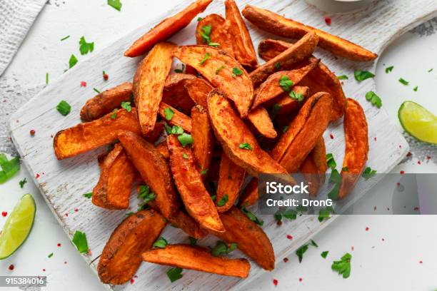 Healthy Homemade Baked Orange Sweet Potato Wedges With Fresh Cream Dip Sauce Herbs Salt And Pepper Stock Photo - Download Image Now