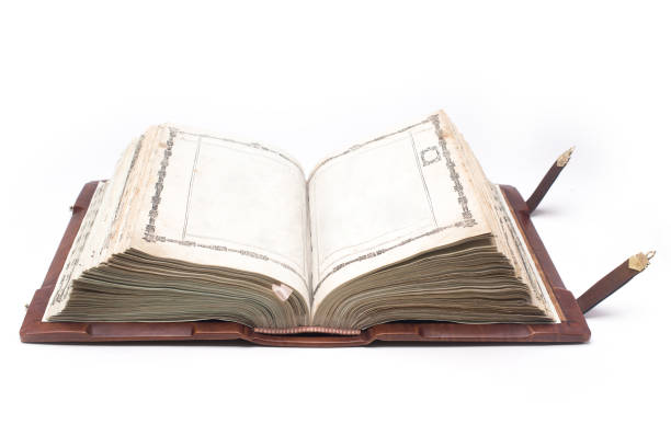 istock Old open antique bible isolated on white background with clipping path. 915387236