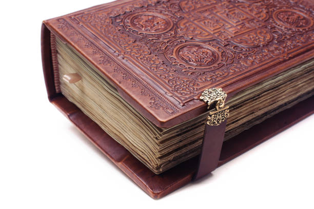 istock A very old leather bound Bible with cross imprint, isolated on white. 915387244