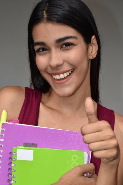 istock Pretty Girl Student With Thumbs Up 915387520