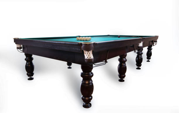istock Full pool table with green top, balls, and cue on white 915387750