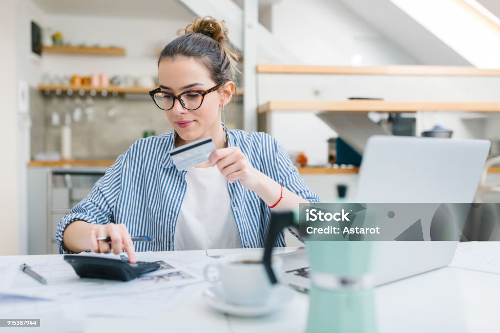 Online shopping Young woman paying bills/ shopping online with credit card Credit Card Stock Photo