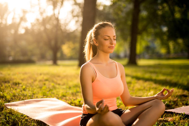istock Meditating in the park 915391412