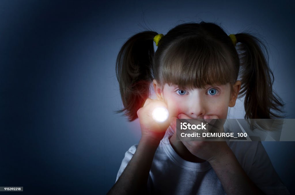 child is afraid of the dark Flashlight Stock Photo