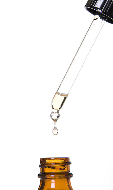 istock Dropper putting clear droplets in brown bottle 91539821