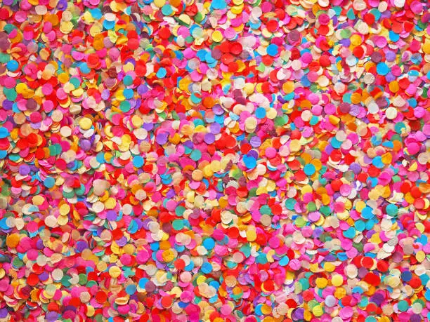 Confetti diversity background. Texture colored circles from paper, close-up. Basis for a festive design or a postcard. Carnival, abstract wedding or birthday backdrop