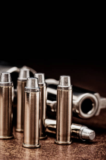 istock Chrome handgun and bullets lying down on the floor 915398784