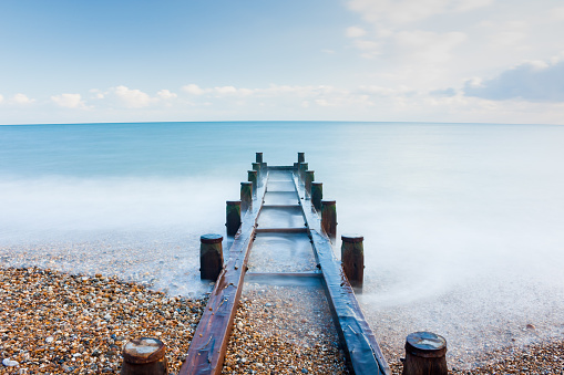 This long exposure photograph was taken on a cold February afternoon and depicts the wooden housing for a surface water pipe, leading out to sea in Bognor Regis, West Sussex