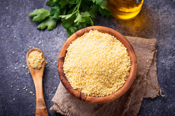 istock Couscous grain in wooden bowl 915404206