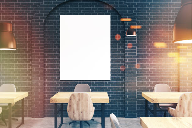 istock Black brick cafe, wooden tables and a poster toned 915414218