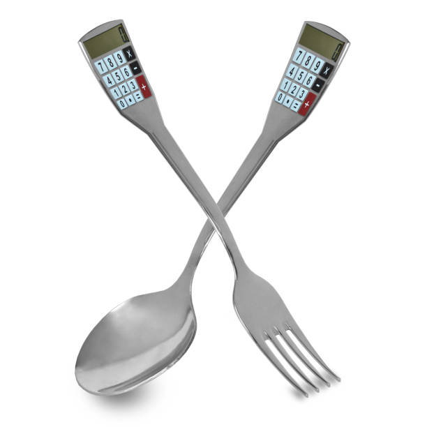 istock Spoon and fork with calorie counter.Cutlery with calculator on white isolated background conceptual photo. 915419682