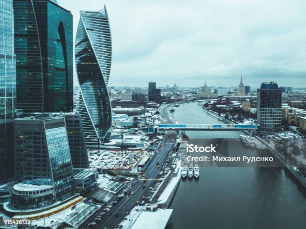 Aerial Drone Shot Of The City Skyscraper Near The River And Bridge During Wintertn Stock Photo - Download Image Now