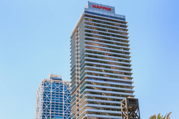 Barcelona, Spain - June 21, 2017 : architectural detail of the MAPFRE tower during the summer, a skyscraper designed by the architects Inigo and Enrique de Leon and built for the 1992 Summer Olympics