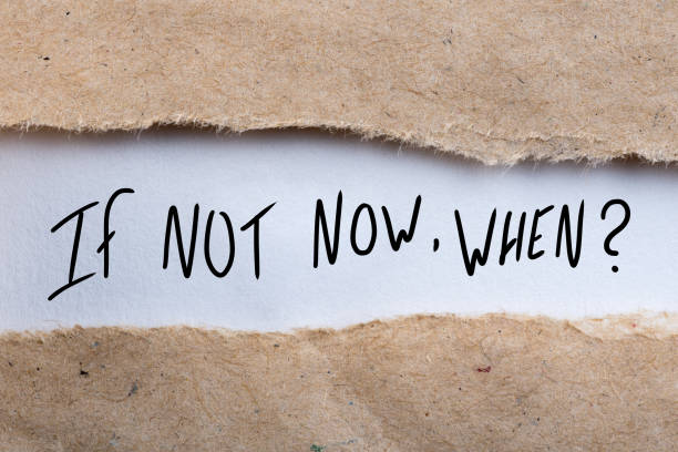 istock If Not Now When, appearing behind torn envelope. Motivating and inspiring question 915443848