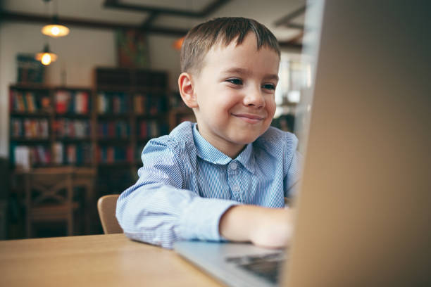 istock Boy typing on the laptop 915445080